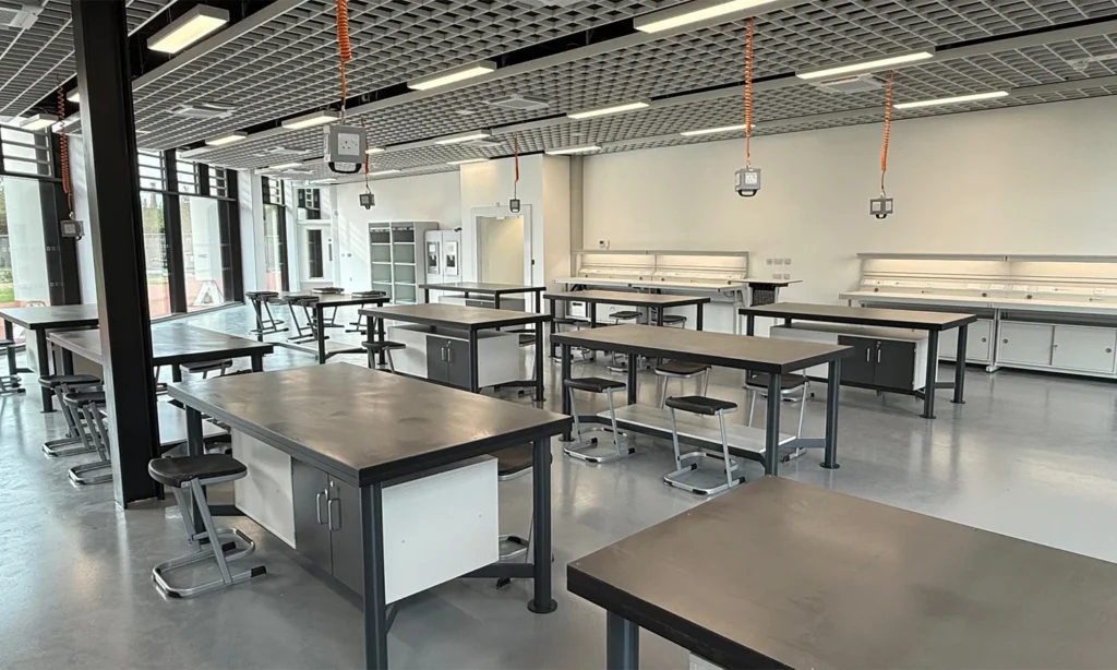 Electronics classroom featuring custom MPDs and perimeter engineering workbenches