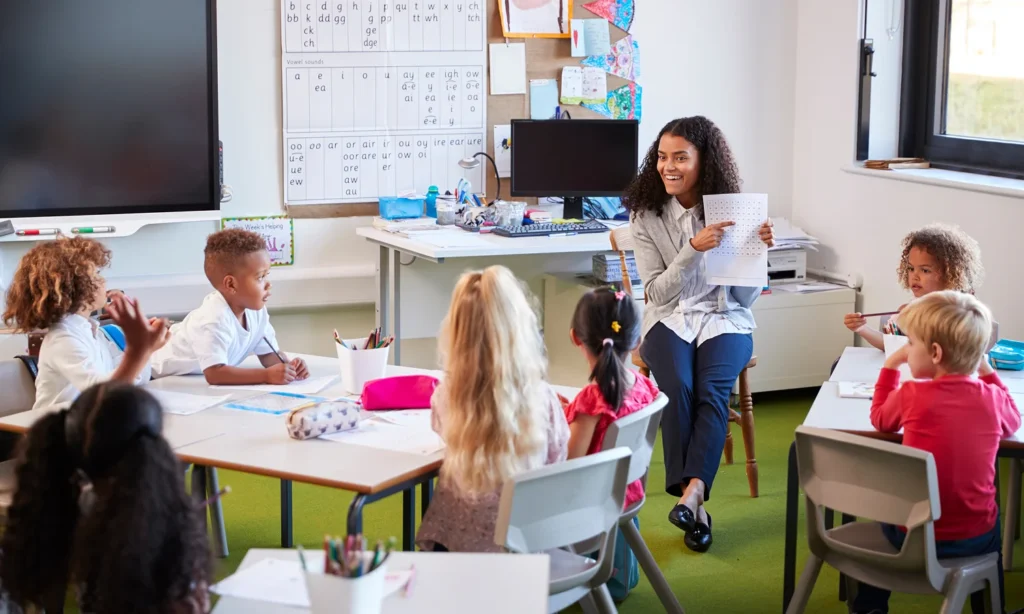Children engaged in classroom learning on school chairs