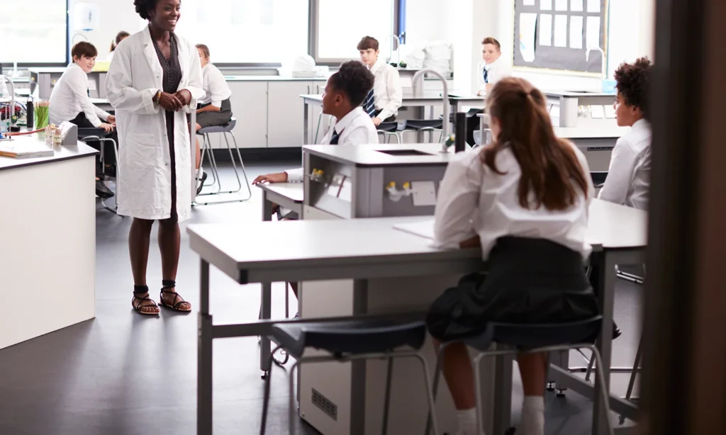students sat on stools learning science