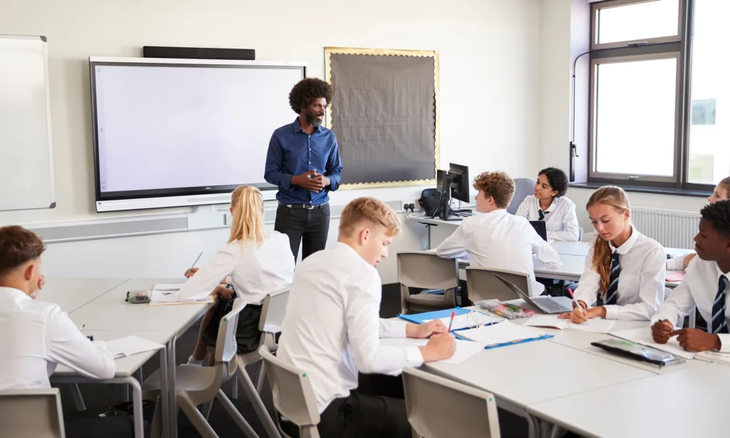 secondary school pupils working at classroom desks