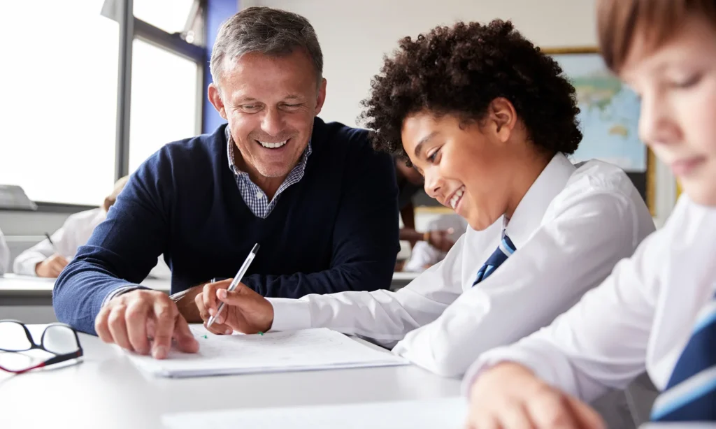 happy teacher giving high school student help